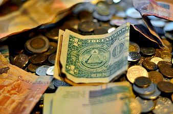 Close-up of mixed international currency and coins