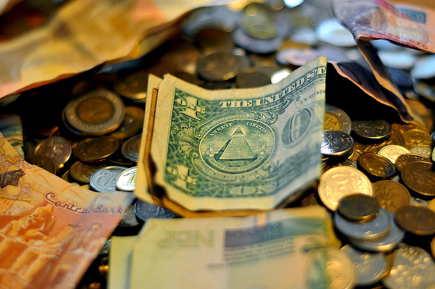 Close-up of mixed international currency and coins