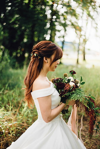 Bride in White Dress Holding Rustic Bouquet Outdoors