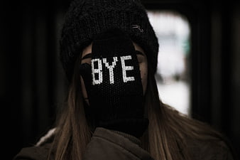Woman with 'BYE' Glove Covering Face in Winter