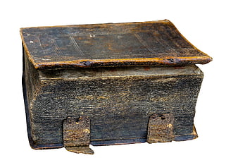 Ancient leather-bound book with metal clasps on white background