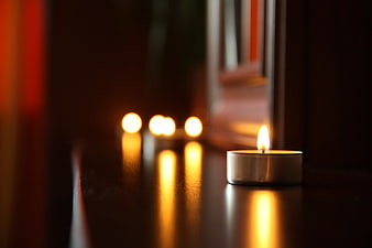 Tealight Candles on Dark Wooden Surface