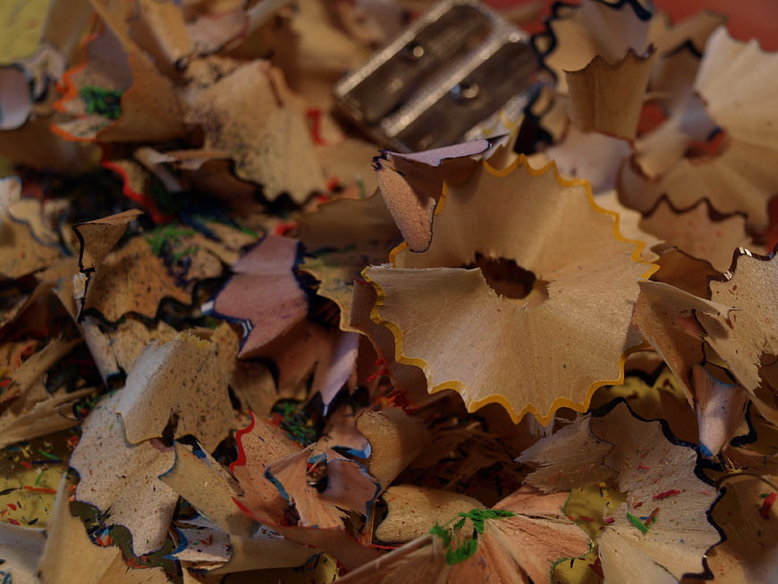 Close-up of colorful pencil shavings and metal sharpener