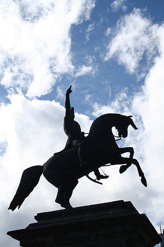 Silhouette of Equestrian Statue Against Blue Sky