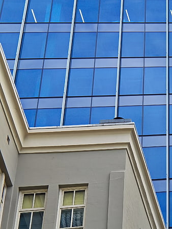 Modern Glass Skyscraper Behind Classic Building Facade
