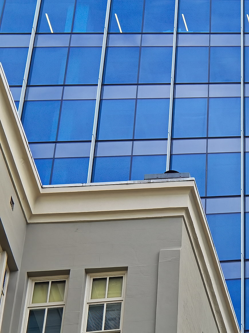 Modern Glass Skyscraper Behind Classic Building Facade