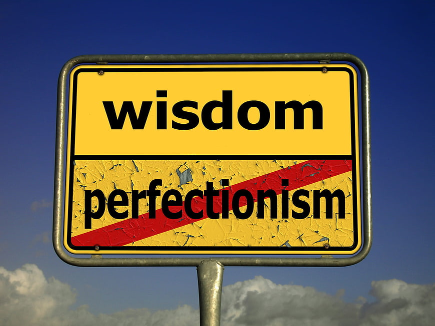 Wisdom vs Perfectionism Road Sign Concept