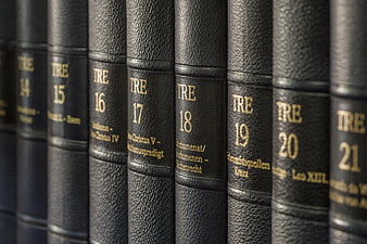 Close-up of vintage black leather encyclopedia volumes with gold lettering
