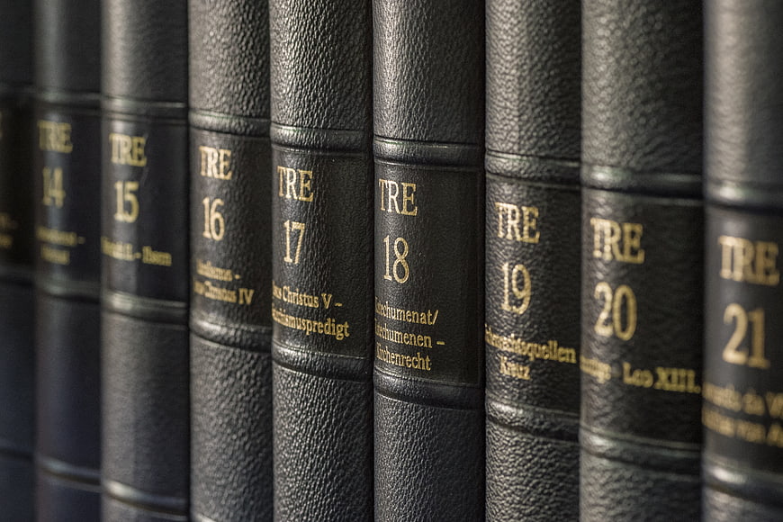 Close-up of vintage black leather encyclopedia volumes with gold lettering