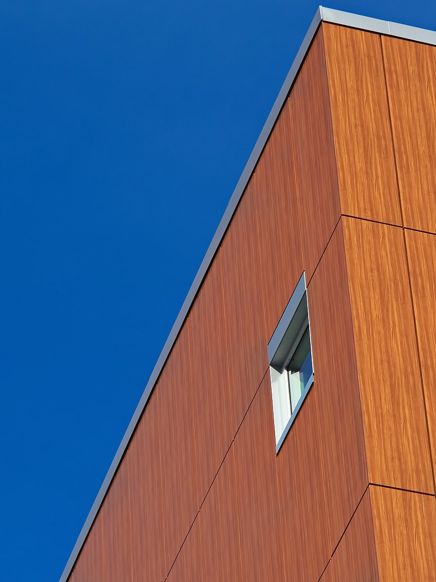 Modern Wooden Building Facade Against Blue Sky