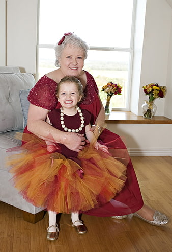 Grandmother and Granddaughter in Matching Red Outfits