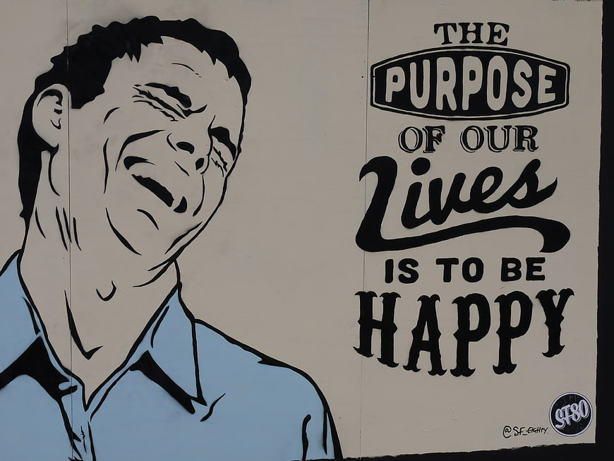 Street Art Mural of Laughing Man with Purpose of Life Slogan