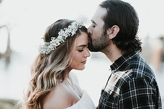 Intimate wedding couple portrait with floral crown kiss