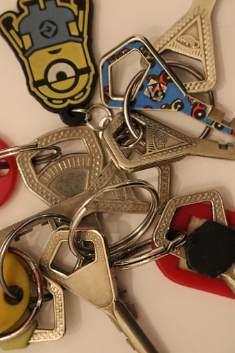 Close-up of mixed car keys and keychains on white background