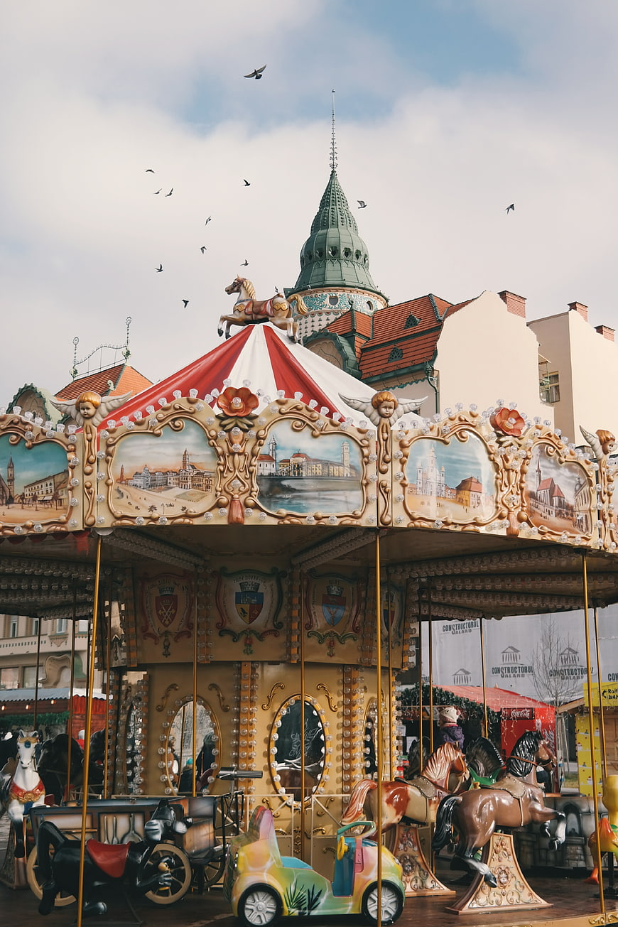Vintage Carousel in European Town Square with Birds