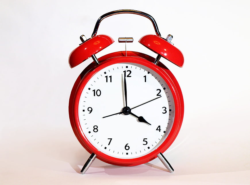 Red Vintage Alarm Clock on White Background