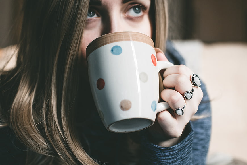 Close-up of woman drinking from polka dot mug
