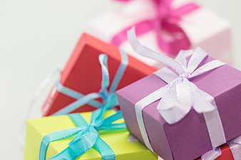 Colorful Gift Boxes with Ribbons on White Background