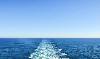 Boat Wake Trail on Deep Blue Ocean Horizon