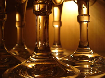 Close-up of elegant wine glasses with golden lighting