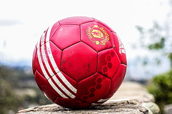Red Manchester United Soccer Ball On Stone Wall