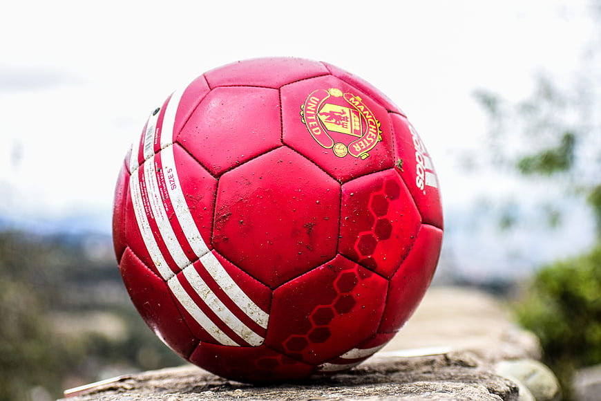 Red Manchester United Soccer Ball On Stone Wall