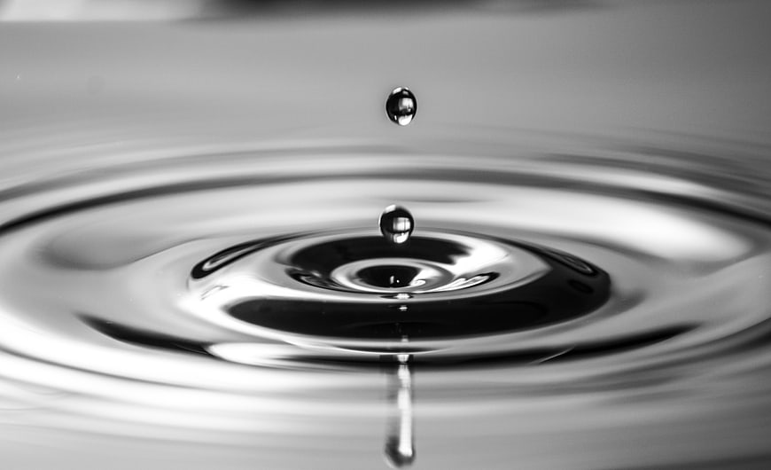 Black and white macro photograph of water droplets and ripples