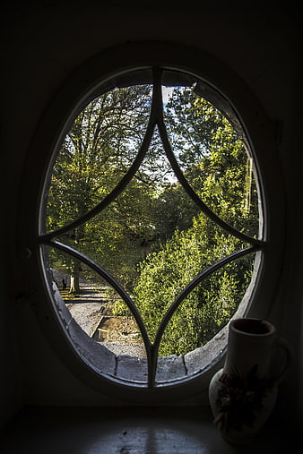 View through gothic arched window with vase