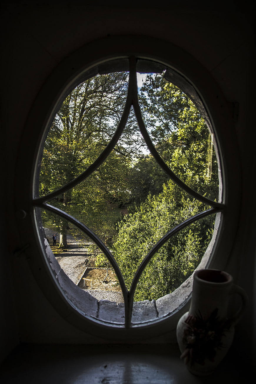 View through gothic arched window with vase