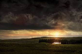 Dramatic Stormy Sunset Over Highland House and Forest