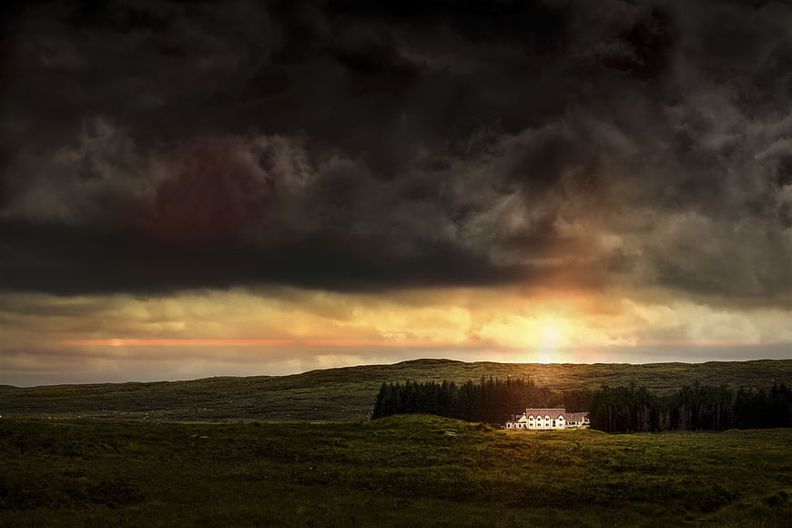 Dramatic Stormy Sunset Over Highland House and Forest