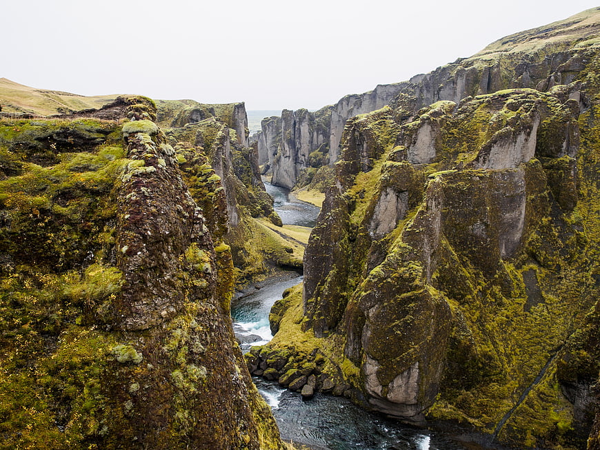Moss-covered basalt cliffs in a dramatic Icelandic canyon