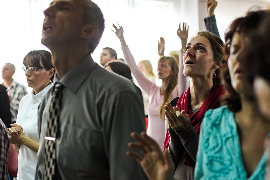 Congregation Praying and Singing in Church Service