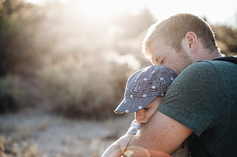 Father Hugging Toddler in Sunlight