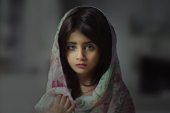 Portrait of a young girl wearing a floral headscarf