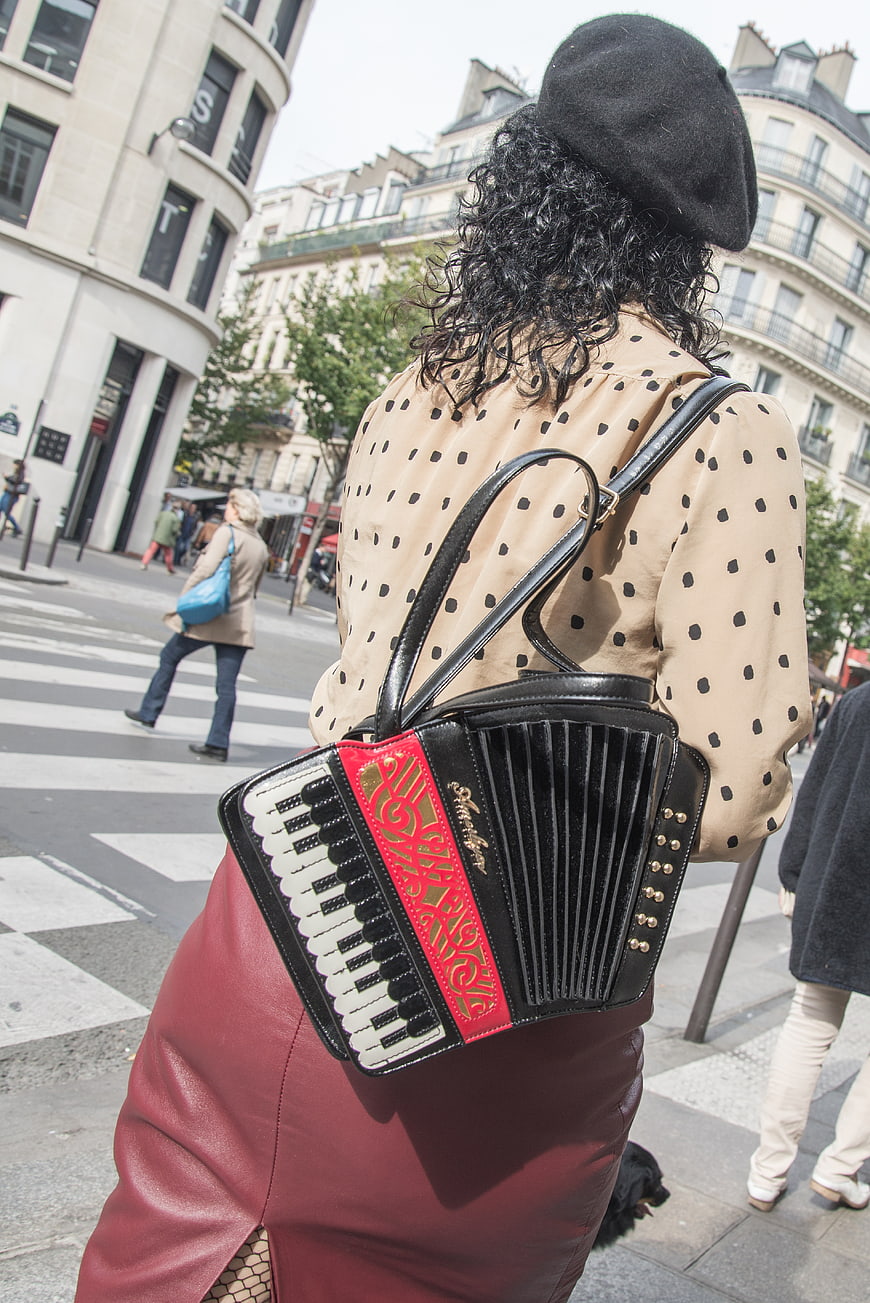 Woman with accordion-shaped handbag on Paris street