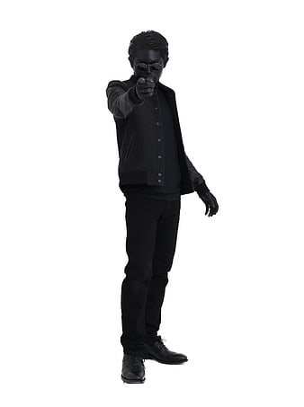 Man in all-black outfit pointing finger at camera on white background