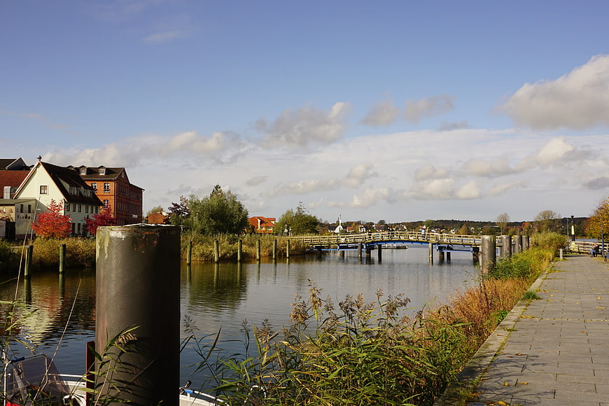 Scenic River View with Wooden Bridge and Autumn Foliage