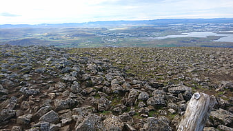 Rugged Icelandic lava field landscape overlooking distant town