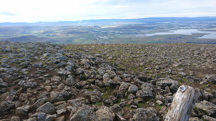 Rugged Icelandic lava field landscape overlooking distant town