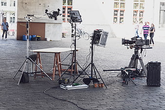 Professional video production equipment set up on a cobblestone street