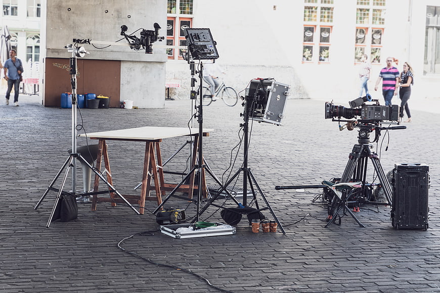 Professional video production equipment set up on a cobblestone street