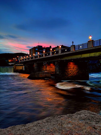Long Exposure Bridge at Dusk Over Flowing River