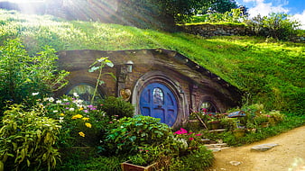 Hobbit House with Blue Door and Lush Garden