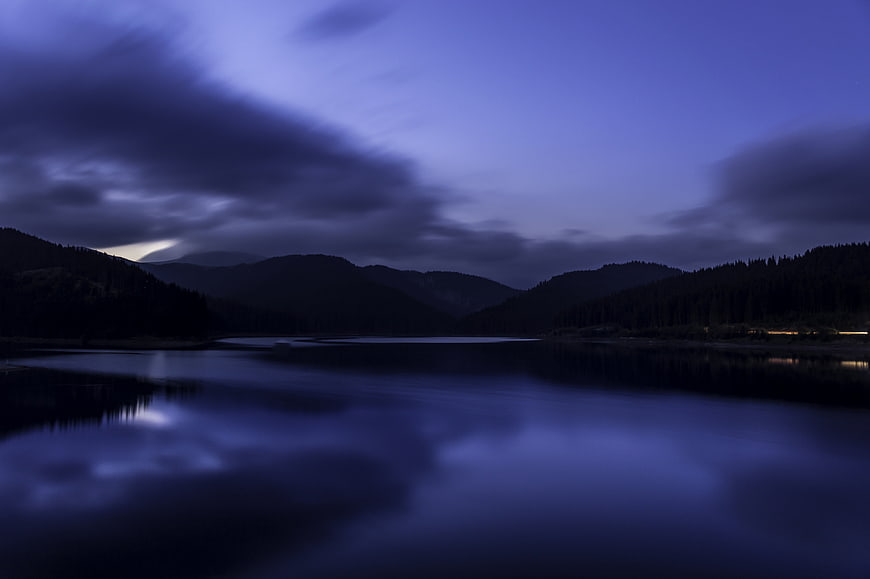 Dark Blue Mountain Lake Landscape At Dusk With Cloudy Sky