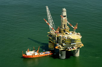 Aerial view of offshore oil rig and supply vessel