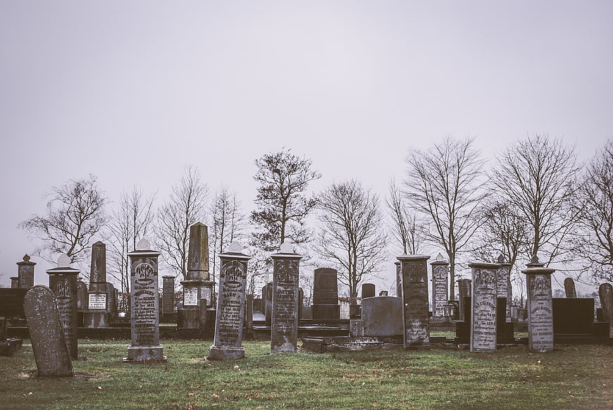 Old Jewish Cemetery with Weathered Tombstones and Bare Trees