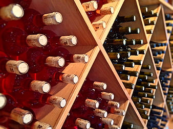 Red and Green Wine Bottles in Wooden Rack