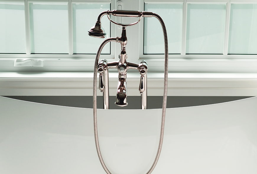 Chrome Bathtub Faucet And Shower Head In Modern White Bathroom