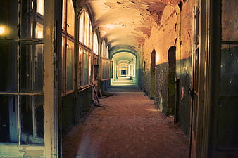 Abandoned Arched Hallway with Peeling Paint and Vintage Windows